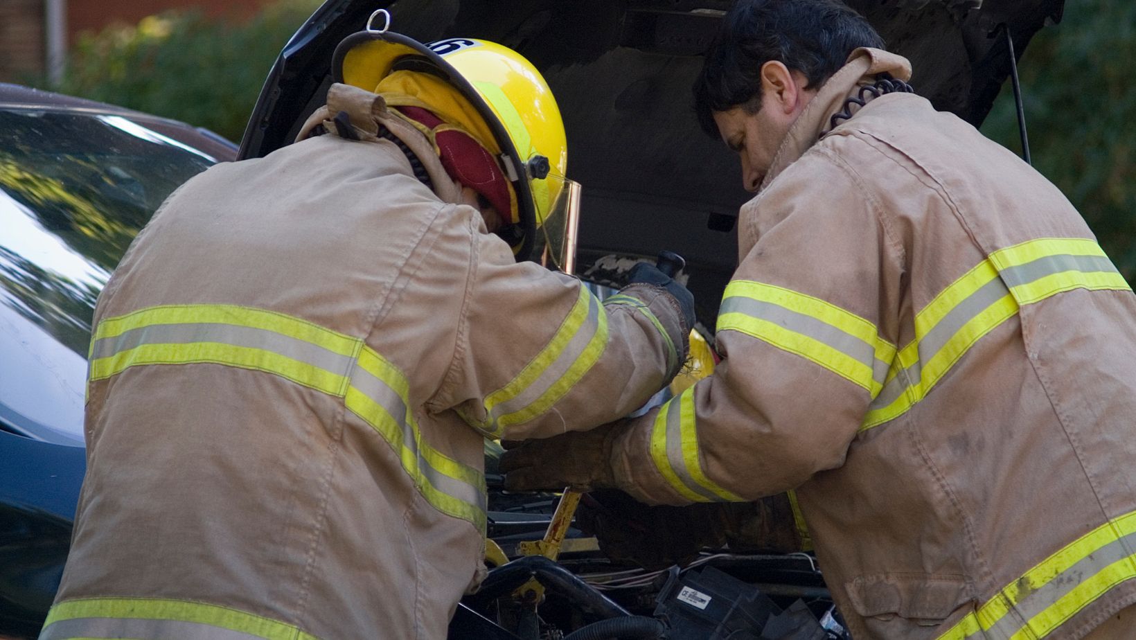 A picture of two firefighters working.