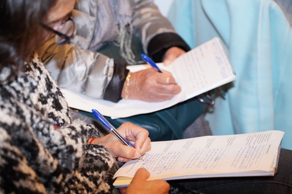 Participants of the event answering questions on a notepad